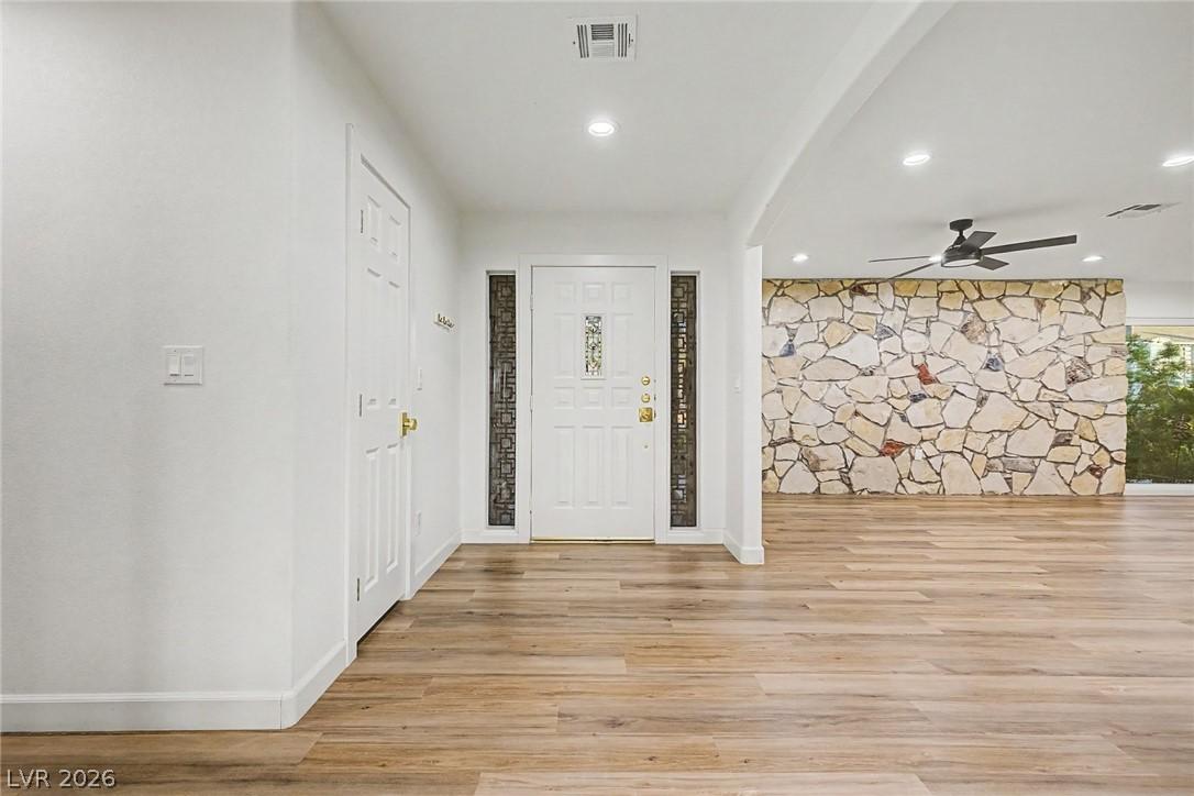 Image 4: Enter into a bright, open living space featuring r