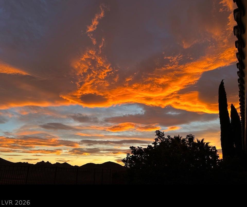 Image 4: Golden hour illuminates dramatic skies above dista