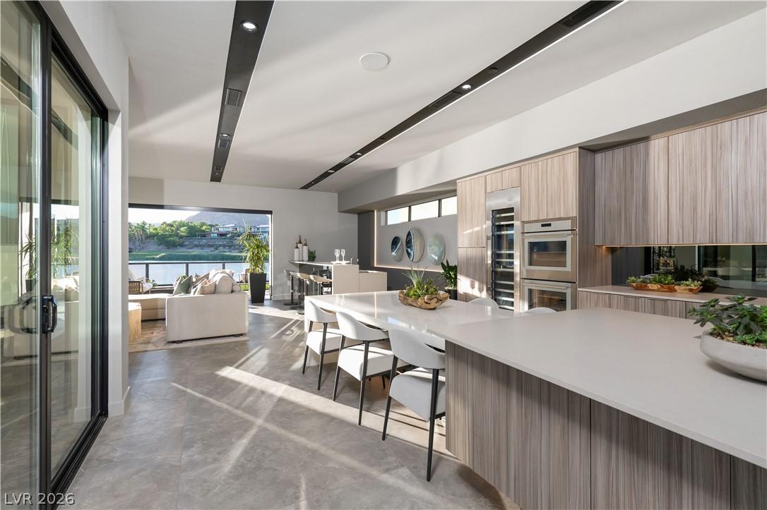 Image 4: An open-concept kitchen and living area, featuring