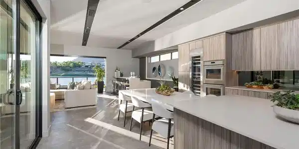 Image 4: An open-concept kitchen and living area, featuring
