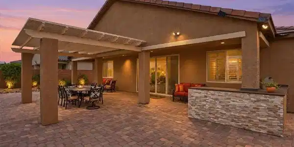 Image 4: A spacious brick paver patio features a built-in s