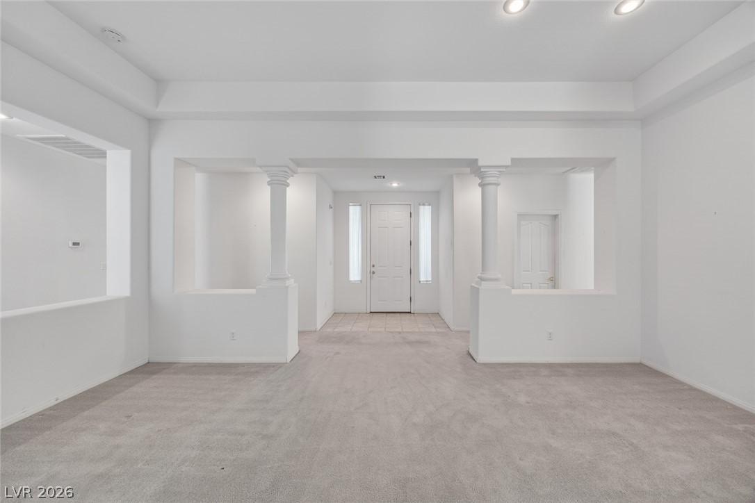 Image 4: Entryway with light colored carpet, recessed light
