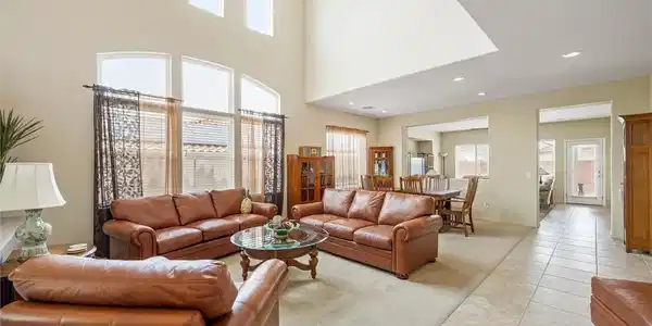 Image 3: A spacious living area features high ceilings and