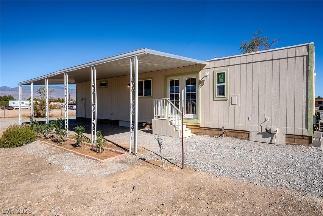 Image 2: A modest home with a covered front patio and simpl