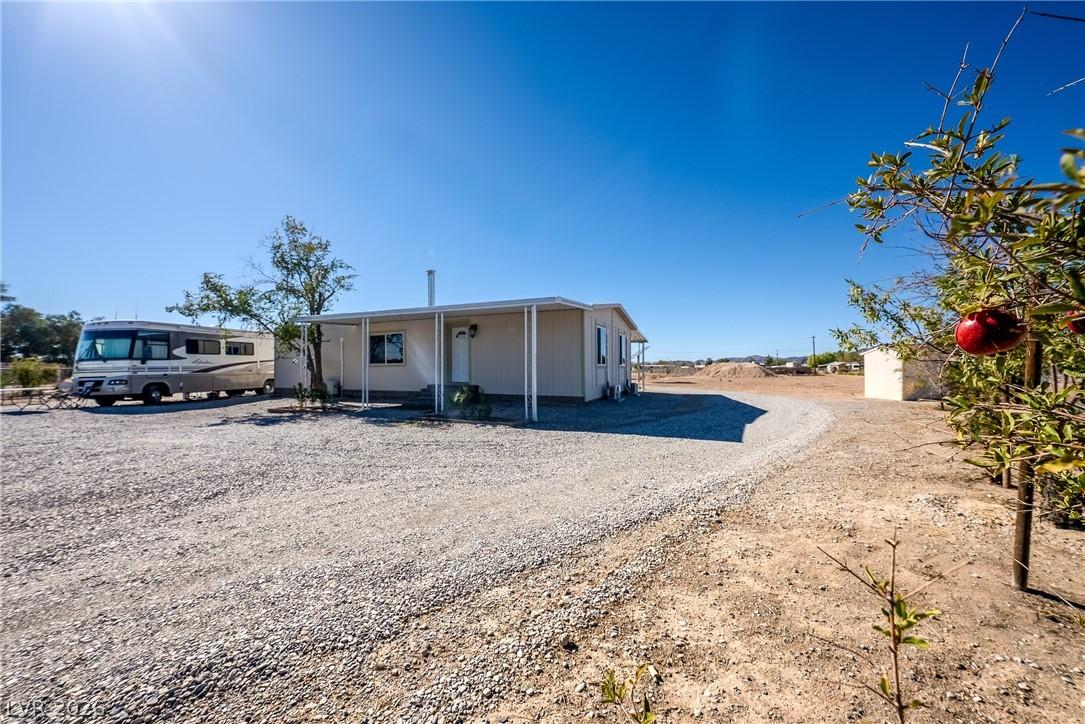 Image 4: A spacious gravel driveway leads to this charming