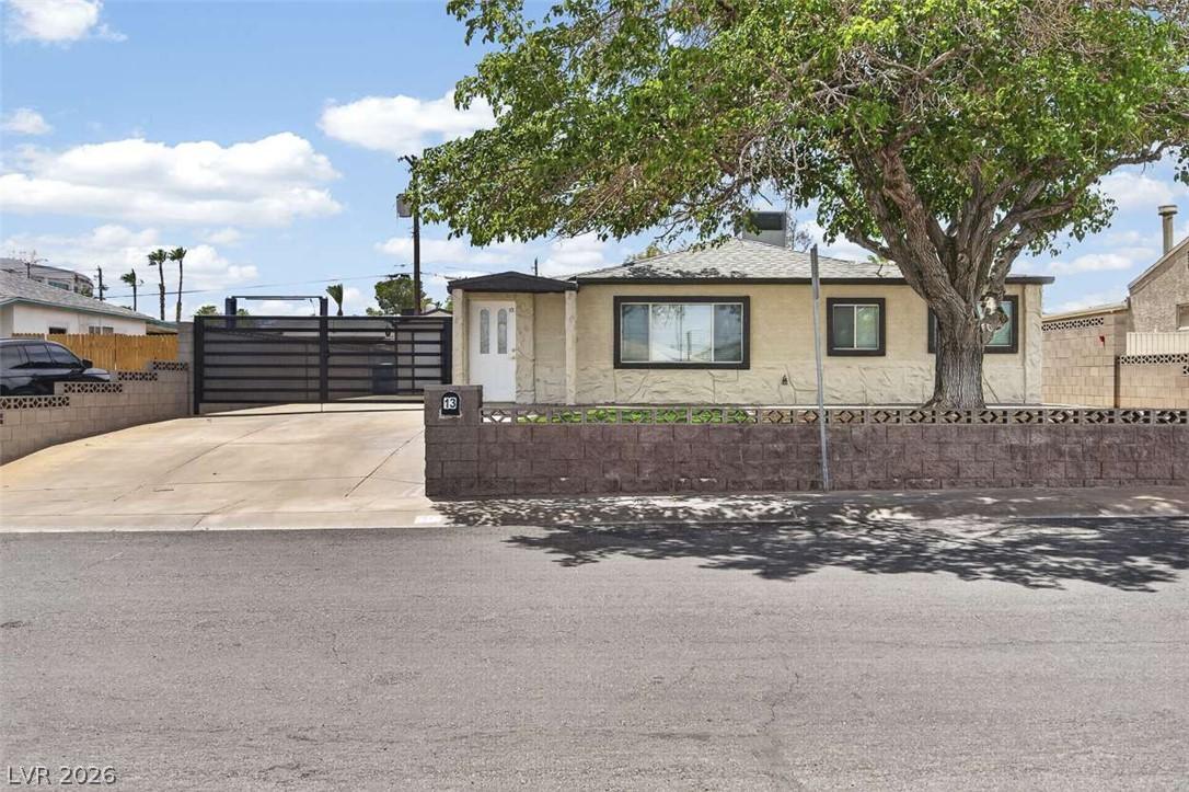 Image 2: Secure, gated driveway leading to a cozy home with