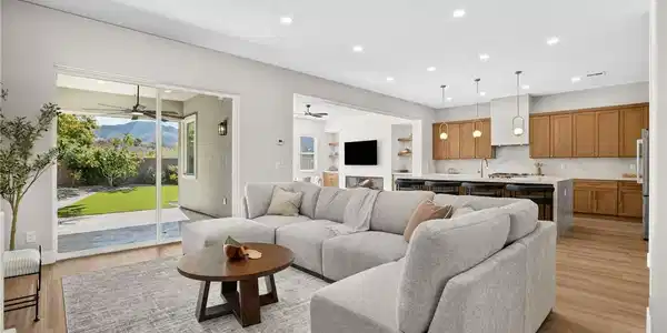 Image 4: An open concept living area transitions to a moder