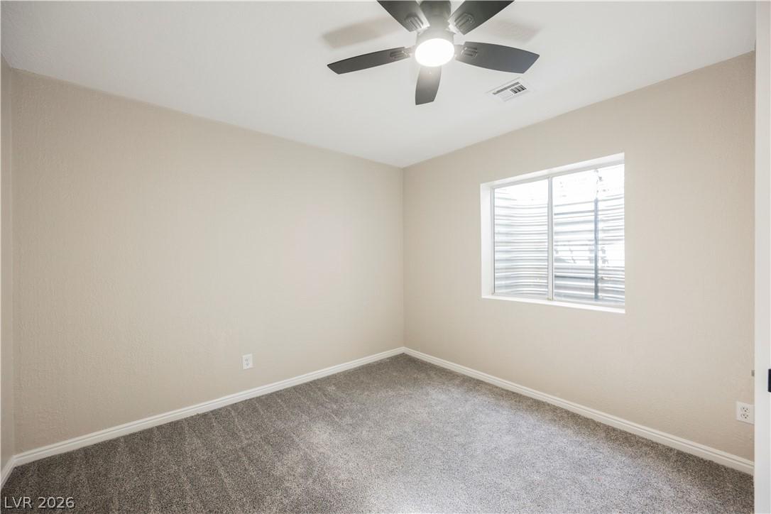 Image 4: A well-proportioned bedroom with new gray carpetin