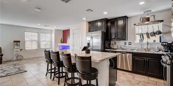 Image 4: An inviting open concept living area showcases a l