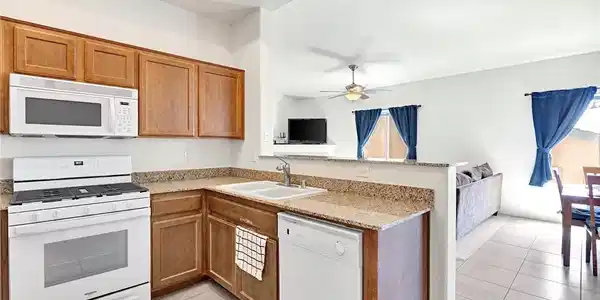 Image 4: This bright kitchen features ample counter space a