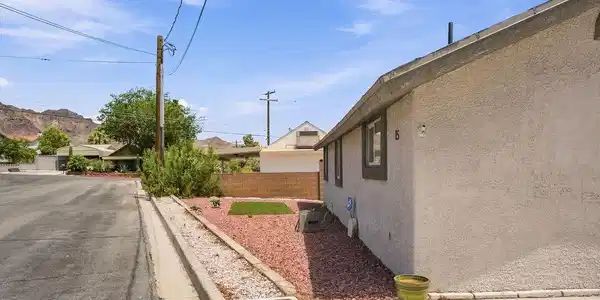 Image 4: Well-maintained stucco home nestled on a spacious