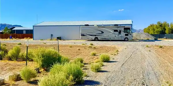 Image 3: A spacious lot featuring a large storage building