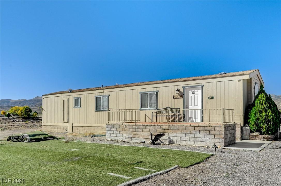 Image 1: Back of house featuring a yard and a mountain view