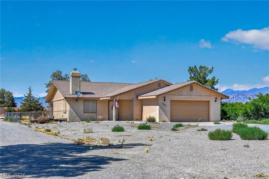 Image 1: A desert oasis with a neutral stucco finish and a