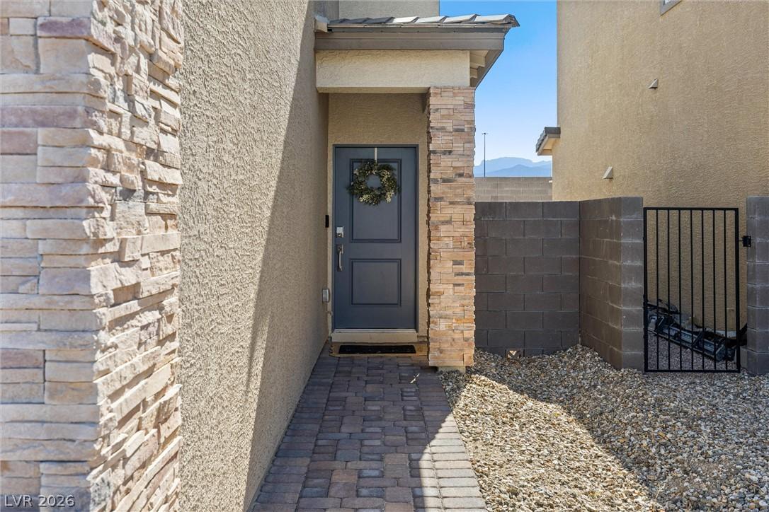 Image 3: A welcoming entry features stone accents, a durabl