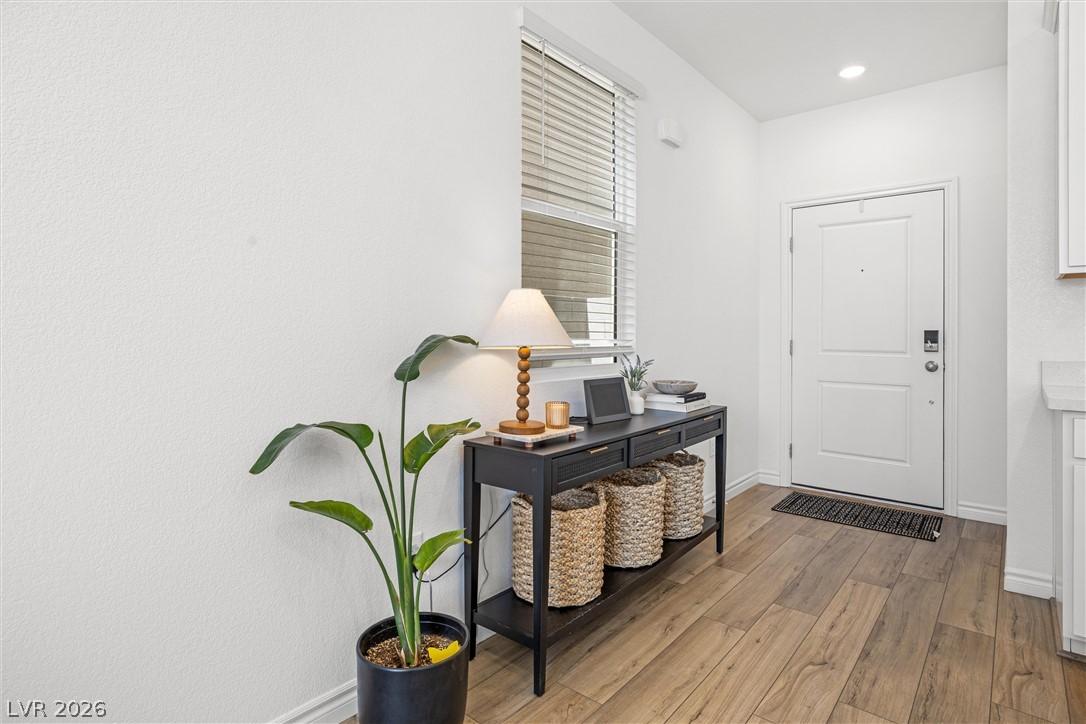 Image 4: A welcoming entryway with rich wood-look flooring
