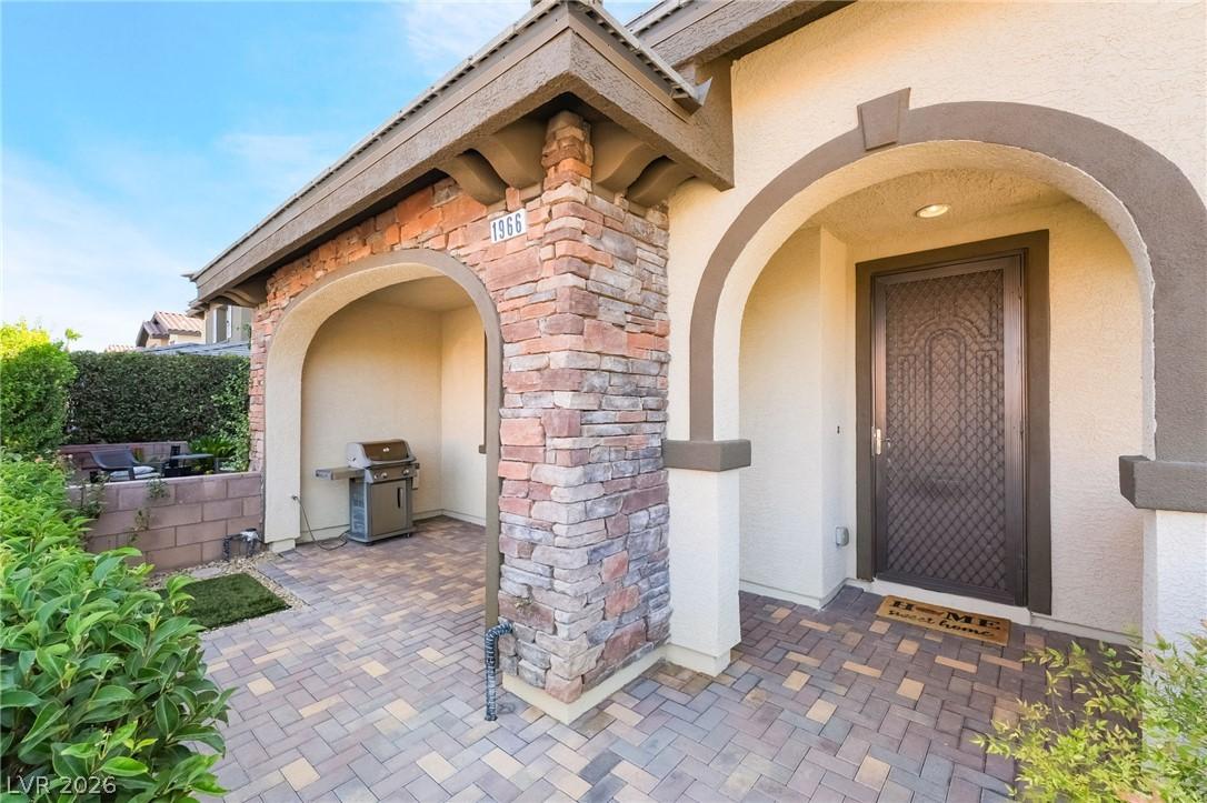 Image 3: Stone accents and an inviting arched entry create