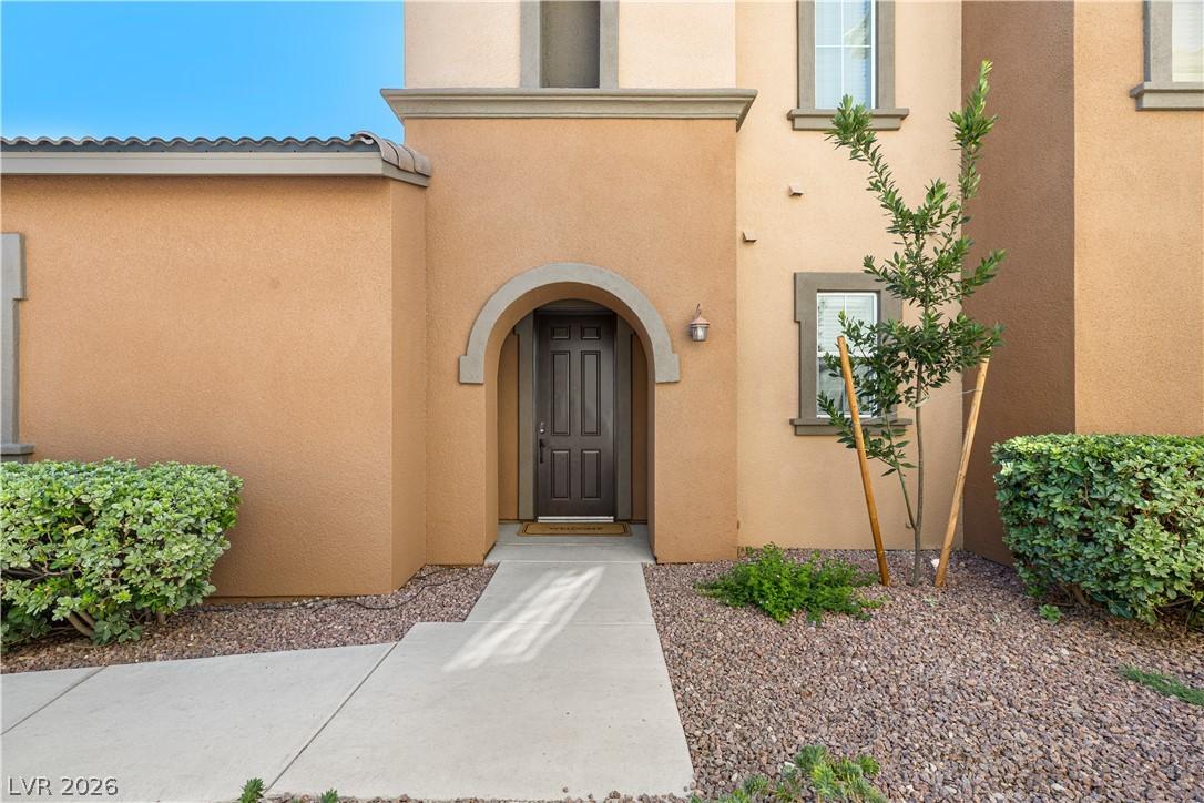 Image 4: An inviting arched entry welcomes you to this stuc