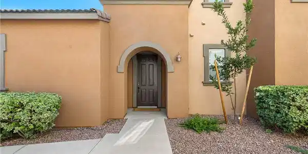 Image 4: An inviting arched entry welcomes you to this stuc