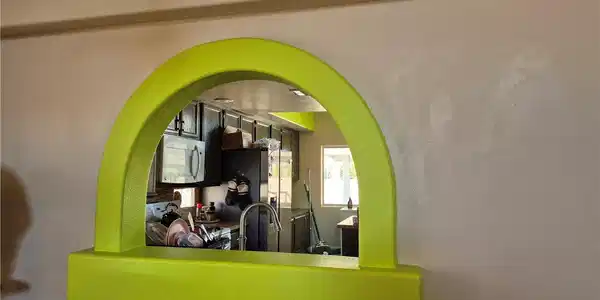 Image 3: An arched pass-through window connects the living