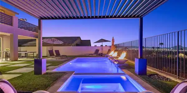 Image 3: An inviting pool and spa rest under the shelter of