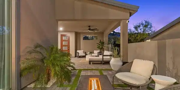 Image 4: An inviting covered patio opens to a paved courtya