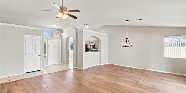 Image 3: Gleaming wood floors and arched transitions define