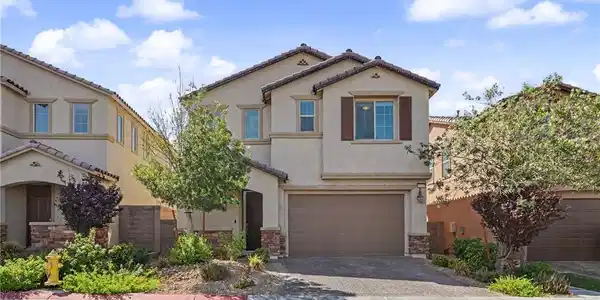 Image 2: Spanish tile roofing and stone accents define this
