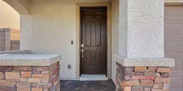 Image 4: An inviting stone-accented entryway features arche