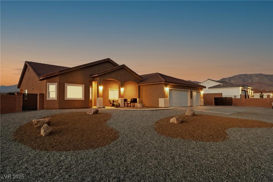 Image 1: View of front of property with concrete driveway,