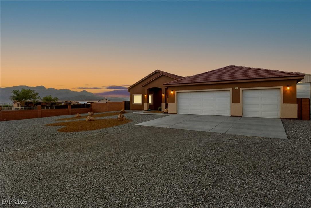Image 3: Ranch-style house featuring concrete driveway, a g