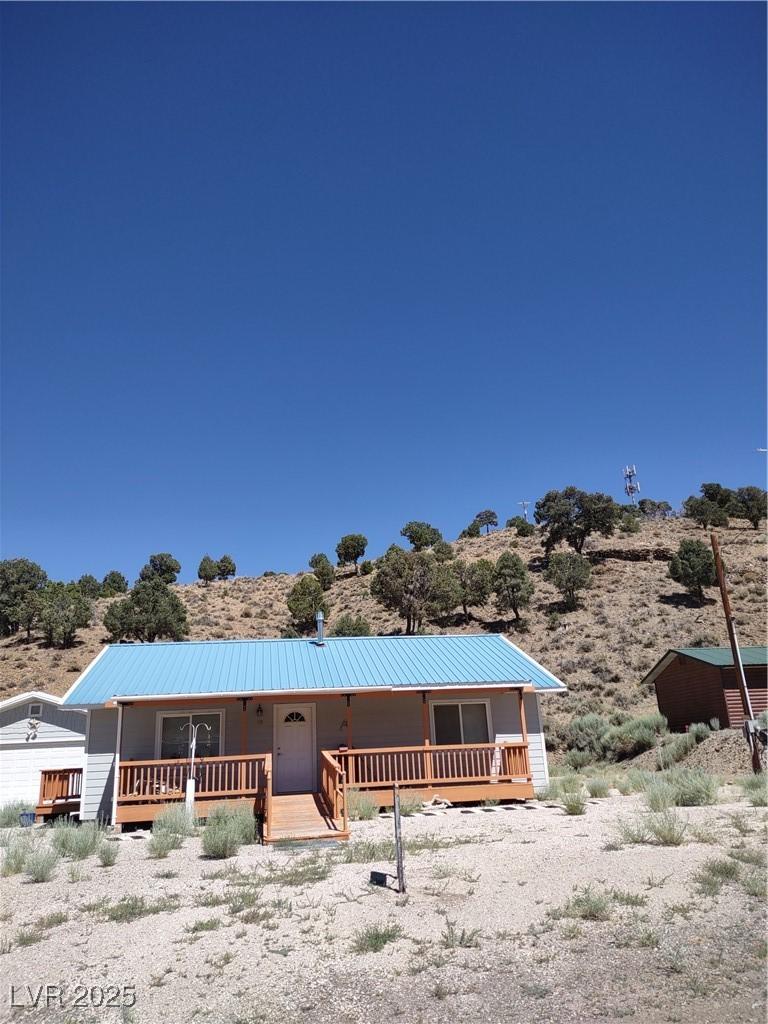 Image 1: View of front of property with a metal roof and co