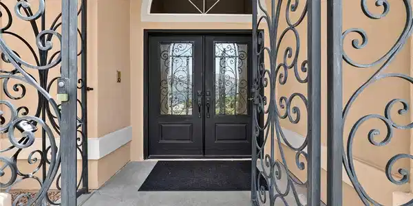 Image 3: Ornate wrought iron gates secure a recessed entryw