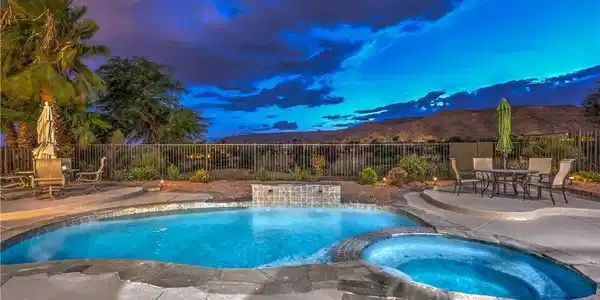 Image 3: An inviting backyard oasis features a sparkling po