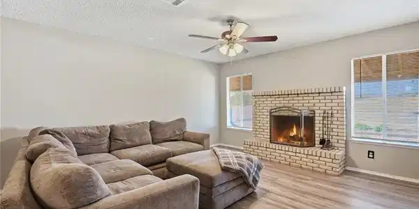 Image 3: Warm and inviting, this living space features a co