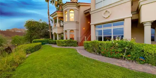 Image 2: Lush manicured lawns and stone pathways wind past
