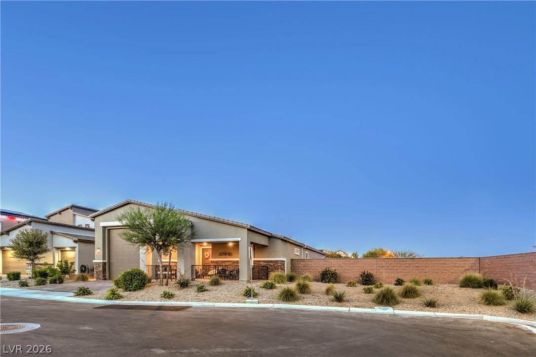 Image 1: A desert-friendly landscape surrounds this charmin