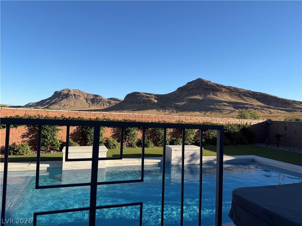 Image 4: An inviting pool area offers breathtaking mountain
