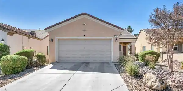 Image 2: Clean lines and a spacious driveway define this mo