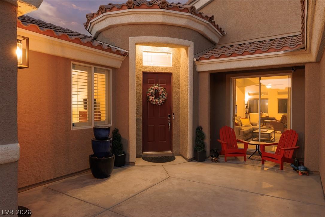 Image 4: A welcoming front entrance featuring stucco siding