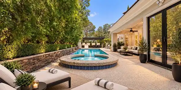 Image 2: A sparkling pool and raised spa anchor this tranqu