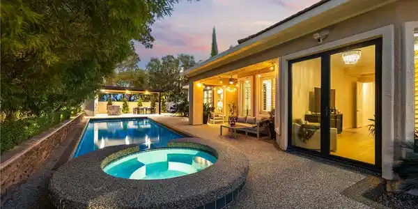 Image 3: An inviting backyard oasis features a custom pool,