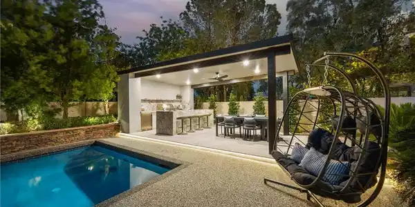 Image 4: An inviting outdoor kitchen and dining pavilion ov