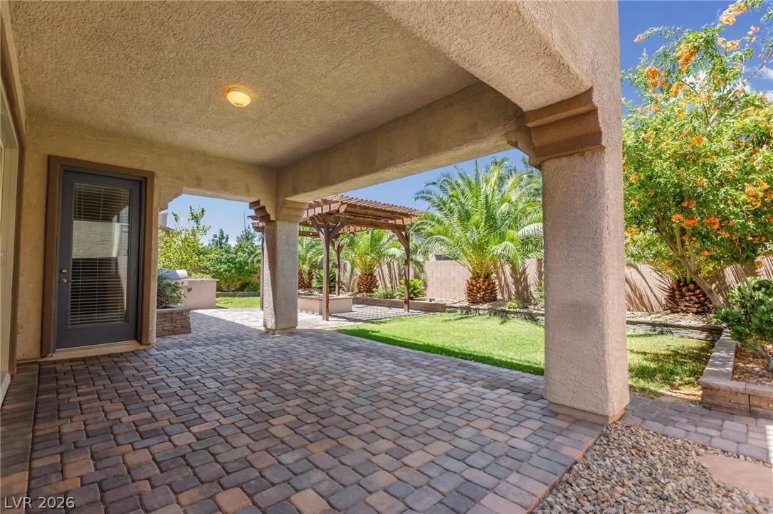 Image 4: A private covered patio extends to a manicured law