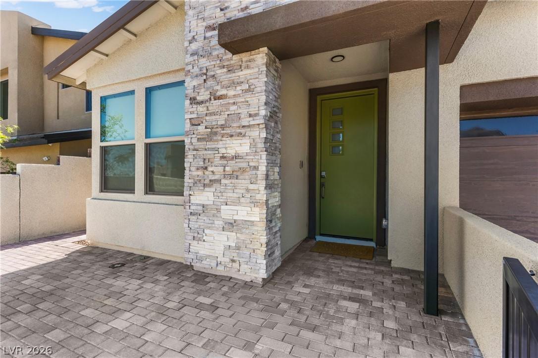 Image 2: A modern facade with stacked stone accents and a v