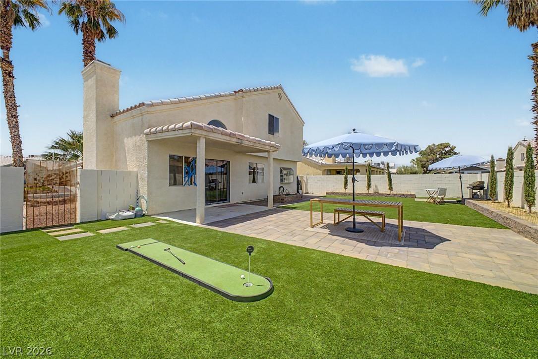 Image 1: A private backyard oasis features a covered patio,