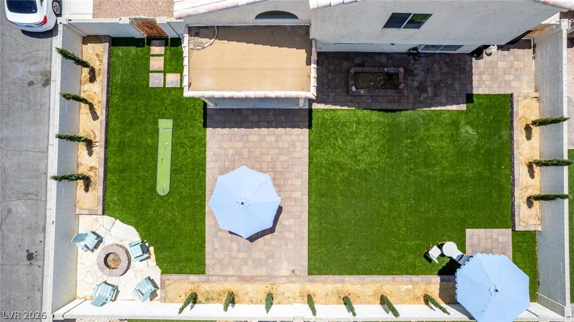 Image 2: A private, paver-lined yard offers an artificial t