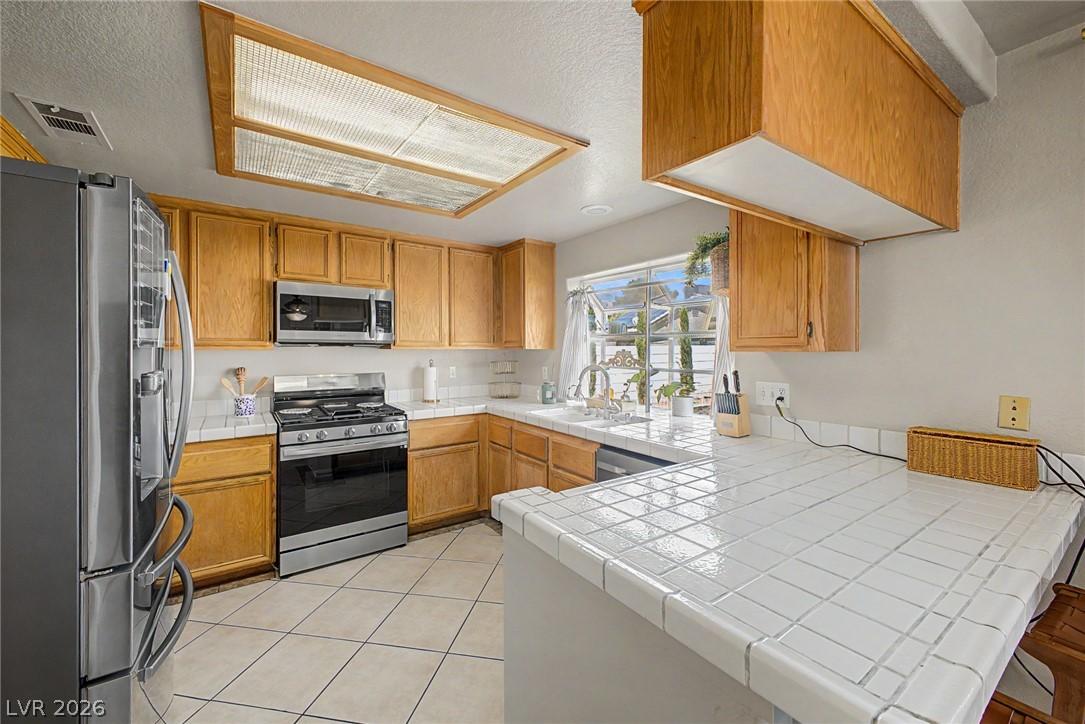 Image 3: A well-equipped kitchen features ample cabinetry,
