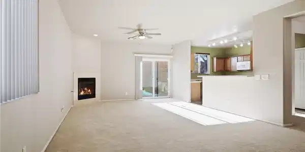 Image 2: An open floor plan connects the carpeted living ro