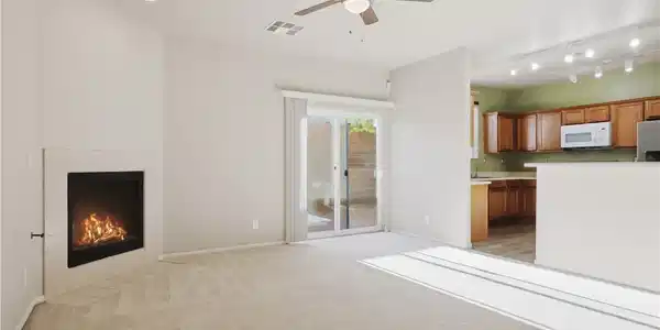 Image 4: An inviting fireplace and sliding glass doors high